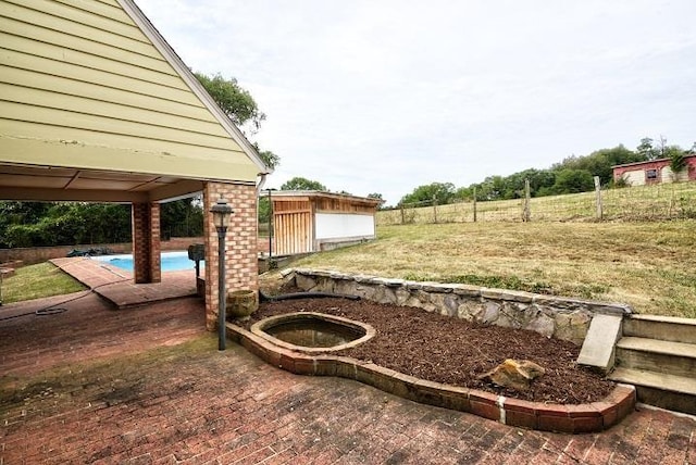 view of yard featuring a patio area and an outdoor pool