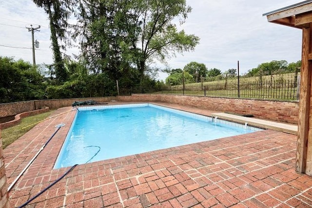 view of swimming pool with a patio area, fence, and a fenced in pool