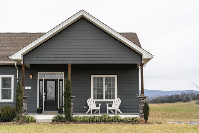 view of front of home featuring a front yard and a porch