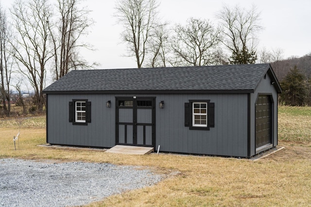 view of outbuilding with a garage and a yard