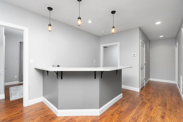 kitchen with pendant lighting, a breakfast bar area, and kitchen peninsula