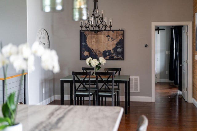 dining space with an inviting chandelier and dark hardwood / wood-style floors