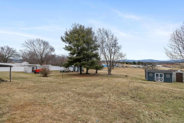 view of yard with a mountain view and a storage shed