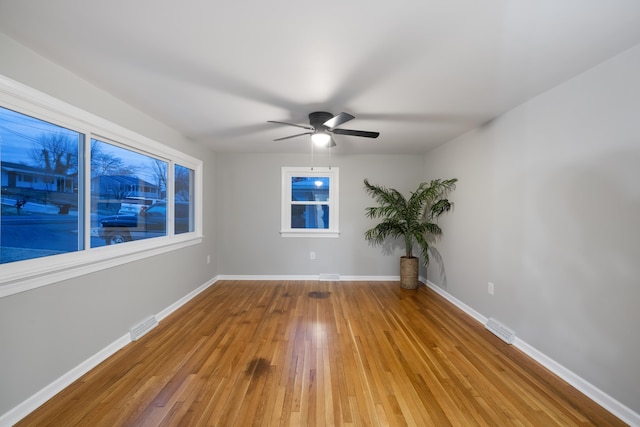 spare room featuring wood-type flooring and ceiling fan