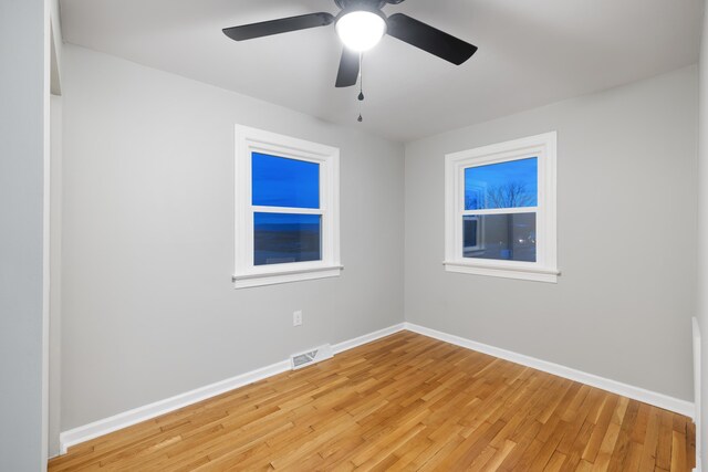 empty room with ceiling fan and light wood-type flooring