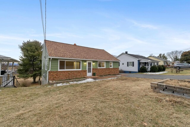 ranch-style home featuring a front yard