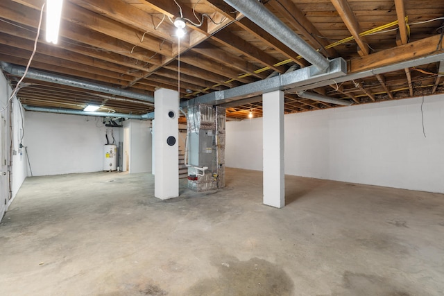 basement featuring water heater and heating unit