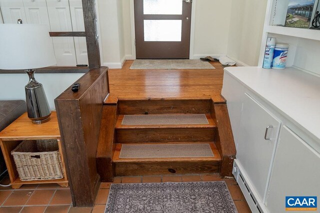 interior space with baseboard heating and wood finished floors