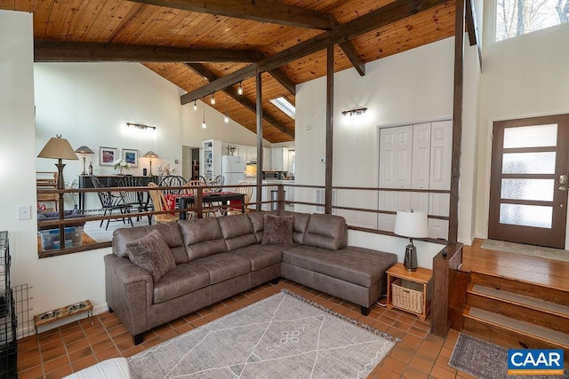 living room with high vaulted ceiling, tile patterned flooring, wooden ceiling, and beam ceiling