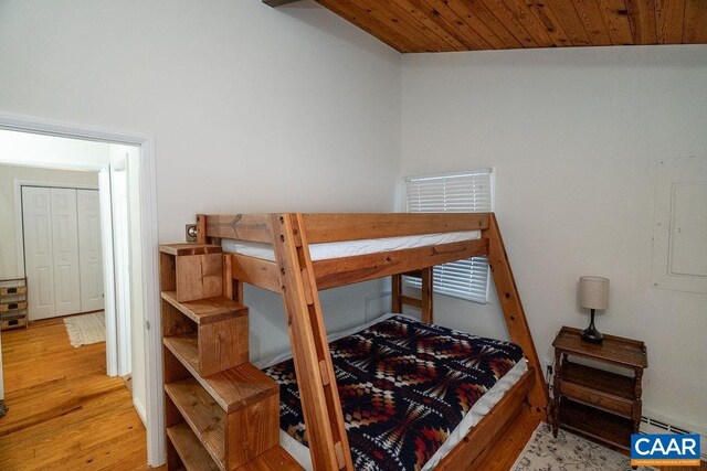 bedroom with wooden ceiling and wood finished floors