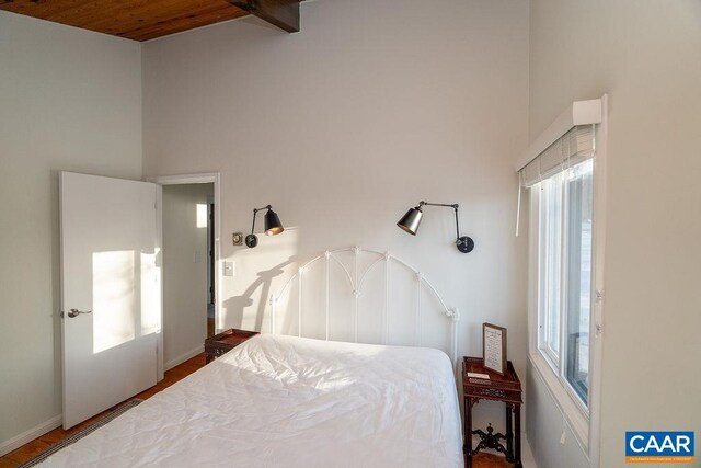 bedroom featuring a towering ceiling