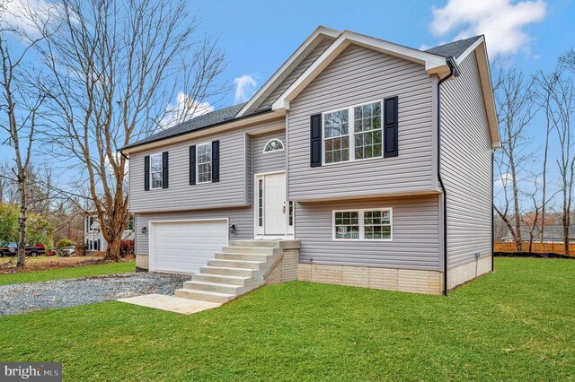 raised ranch with a garage and a front lawn