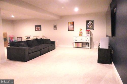 living area featuring carpet flooring and baseboards