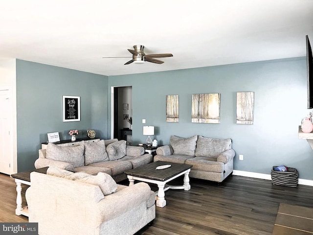 living room with ceiling fan, baseboards, and dark wood-style flooring