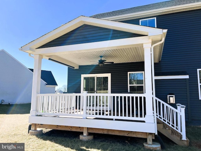 back of property with a ceiling fan