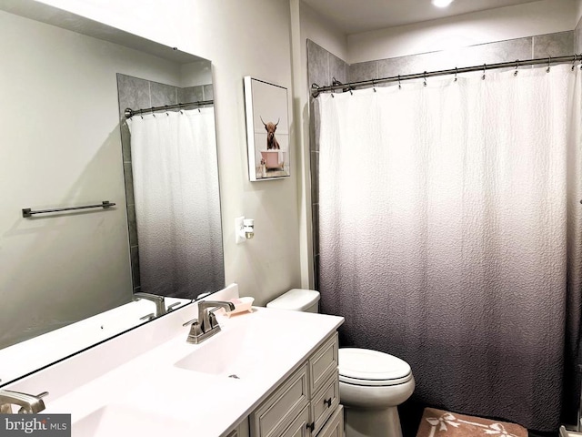 bathroom with toilet and vanity