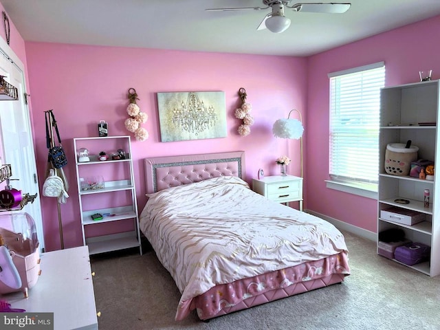 carpeted bedroom featuring ceiling fan and baseboards