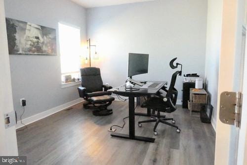 home office featuring baseboards and wood finished floors