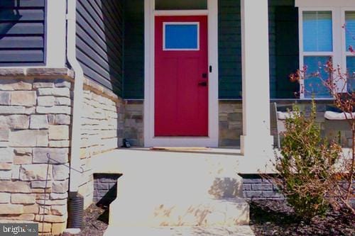 entrance to property featuring stone siding