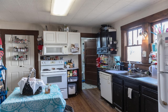 kitchen with white cabinetry, white appliances, dark wood-style floors, and a sink