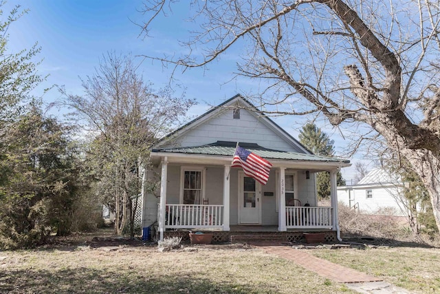 view of front of home featuring metal roof and a porch