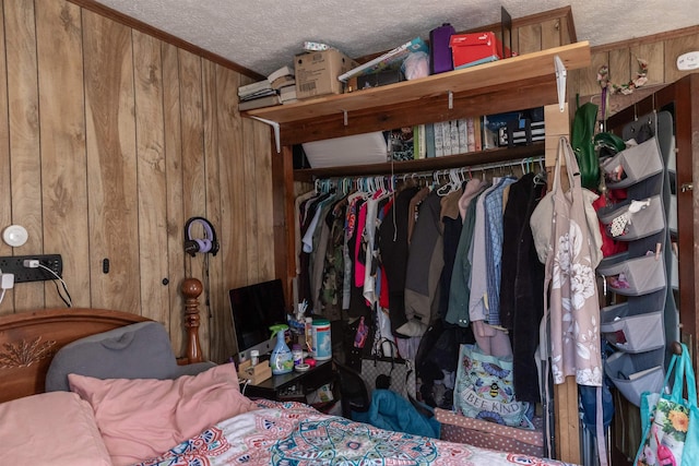 interior space with a closet, wooden walls, and a textured ceiling