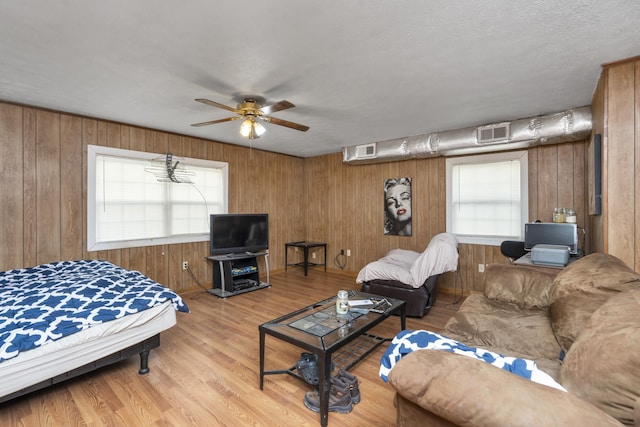 living room featuring visible vents, a ceiling fan, and a healthy amount of sunlight