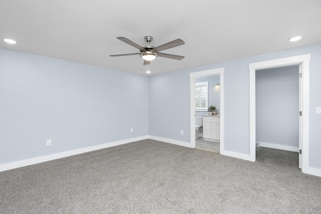 unfurnished bedroom with baseboards, a ceiling fan, recessed lighting, ensuite bath, and light carpet