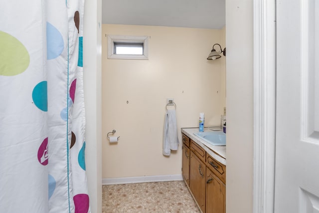 bathroom featuring baseboards, vanity, and a shower with curtain