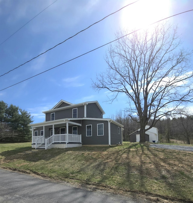 view of front of home featuring covered porch and a front yard