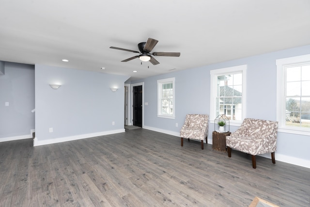 unfurnished room featuring a wealth of natural light, dark wood-style flooring, and a ceiling fan
