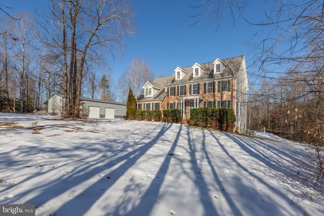 new england style home with a garage