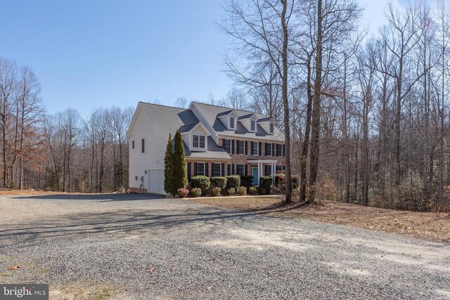 view of front of house with a garage and central air condition unit