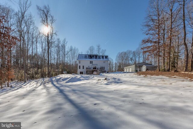 view of snow covered rear of property