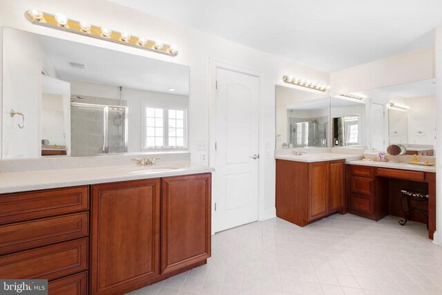 bathroom featuring vanity and a shower with shower door