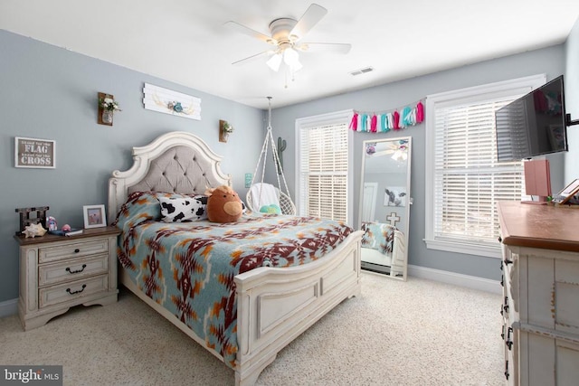 bedroom with multiple windows and ceiling fan