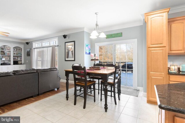 dining area with crown molding and a notable chandelier