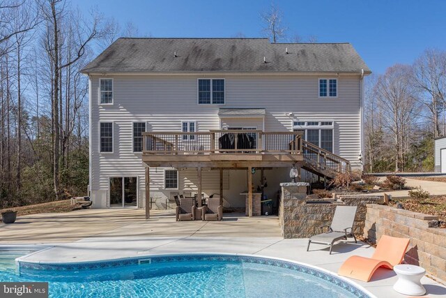 snow covered pool with an outdoor structure, a diving board, and a deck