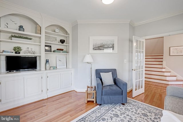 interior space with baseboards, stairs, light wood-type flooring, ornamental molding, and french doors