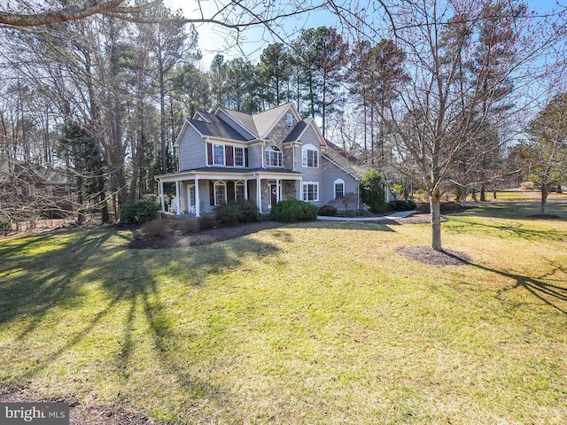 view of front of house with a porch and a front yard