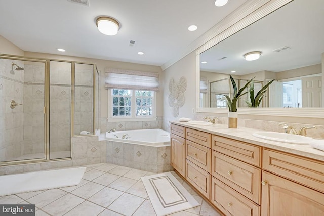 bathroom with a bath, a stall shower, and a sink