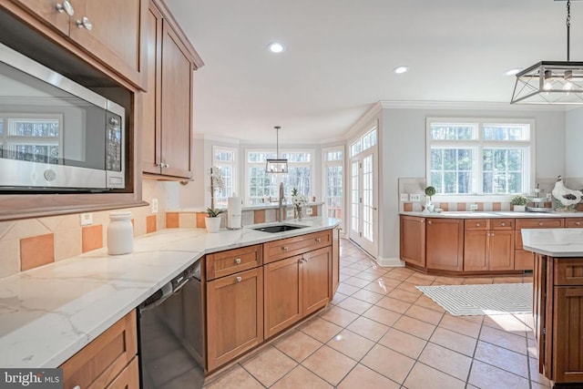 kitchen with ornamental molding, a sink, stainless steel microwave, light tile patterned flooring, and dishwasher