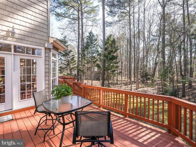 wooden deck featuring outdoor dining area