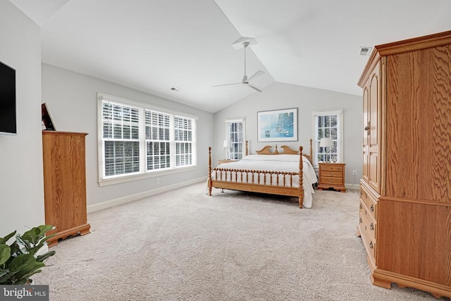 bedroom featuring visible vents, light colored carpet, baseboards, and lofted ceiling