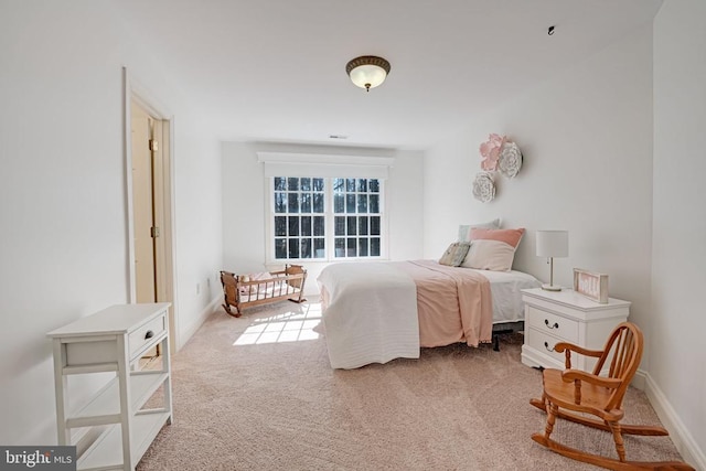 bedroom with baseboards and carpet