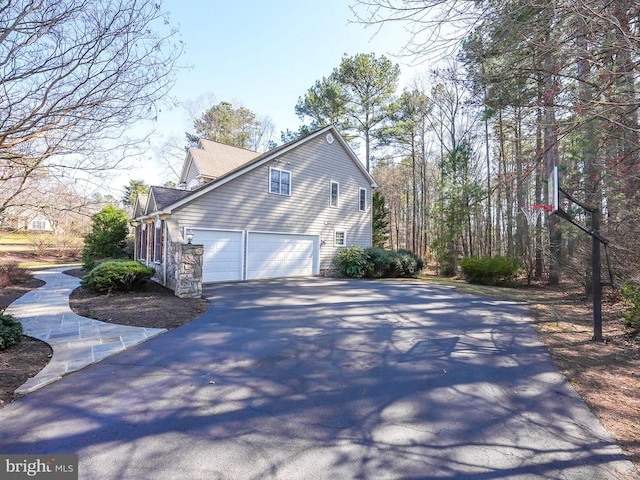 view of side of property with a garage and driveway