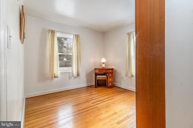 empty room featuring baseboards and wood finished floors