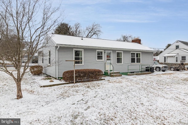 single story home featuring a chimney