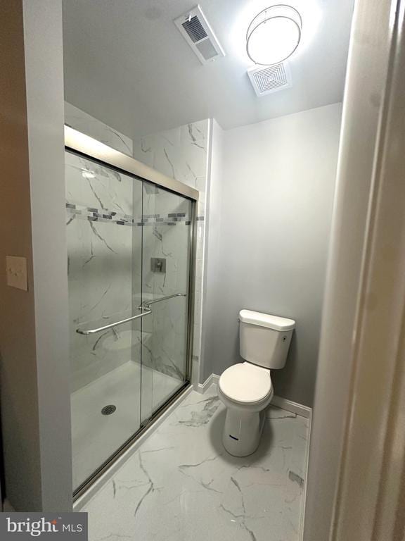 bathroom featuring visible vents, a marble finish shower, toilet, and marble finish floor