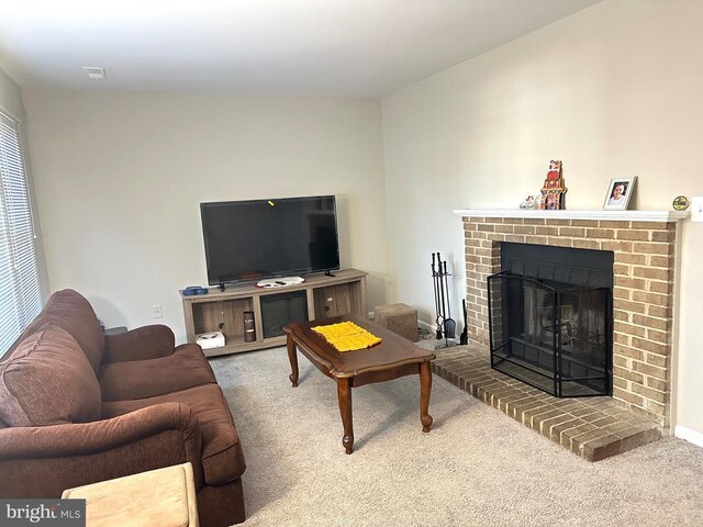 carpeted living room with a brick fireplace